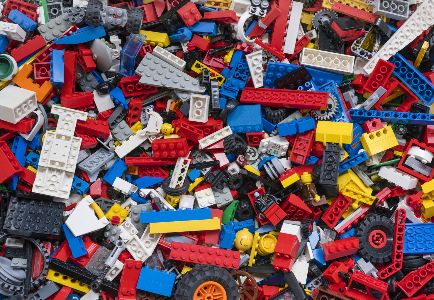 Cluttered pile of many colourful Lego bricks