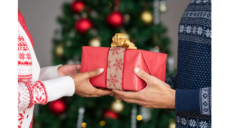 Hands giving christmas gifts