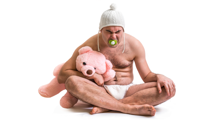 Man as baby. Child in diaper with pink teddy bear.