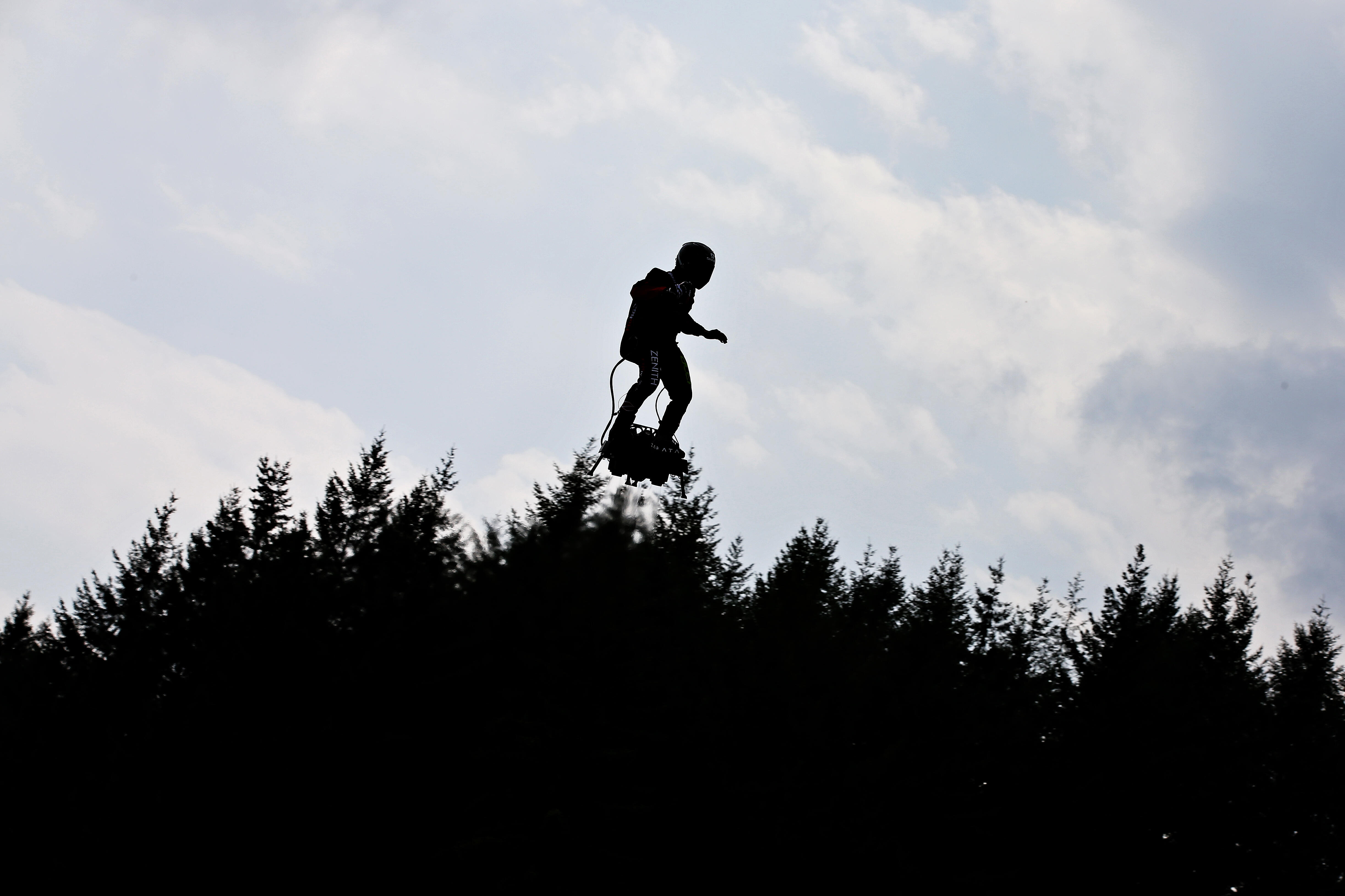 Watch three guys with jetpacks fly in formation with airplanes