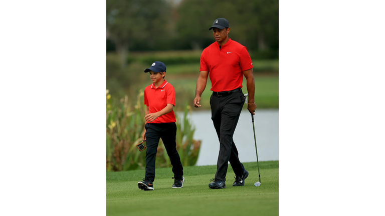 Charlie Woods and his dad, Tiger, prowl the course in the final round of the PNC Championship on Dec 20, 2020 in Orlando