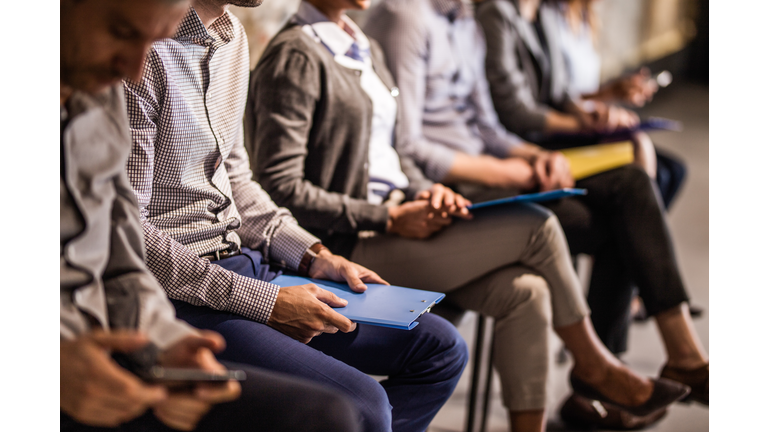 Group of unrecognizable candidates waiting for a job interview.