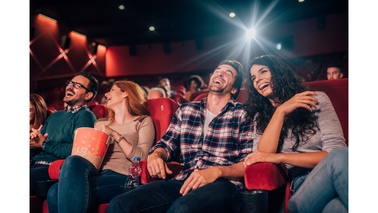 Laughing young people at cinema