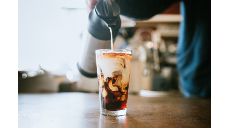 Barista Pours Milk Into Cold Brew Coffee