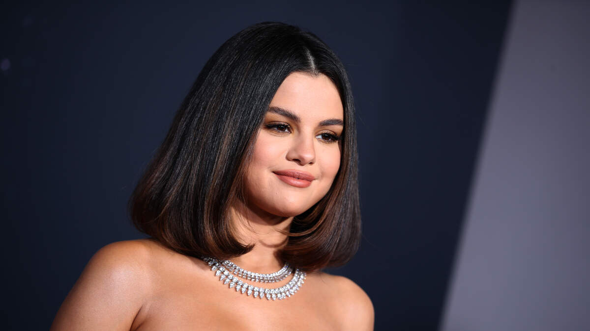Selena Gomez goes bra-free in a nude top while shopping in Louis Vuitton