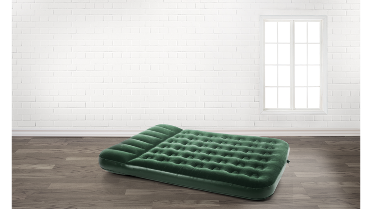 inflatable mattress in an empty room