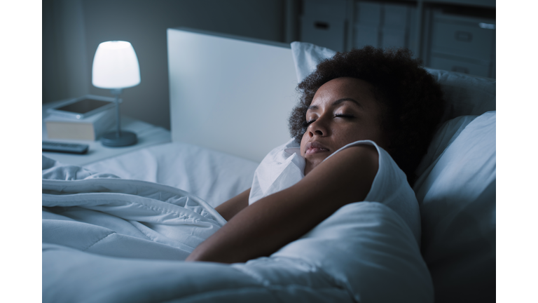 Woman sleeping in her bed