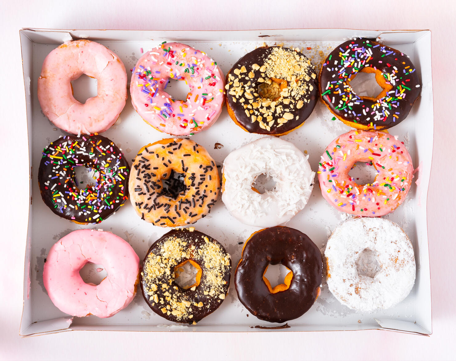 Freshy baked donuts in a cardboard delivery box