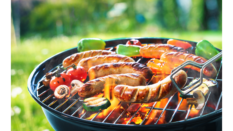 Grilled sausage on the flaming grill