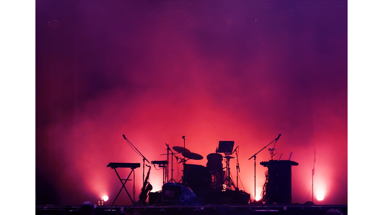 concert stage on rock festival, music instruments silhouettes