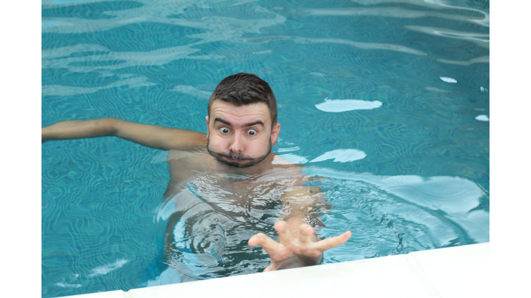 Man trying to reach the border in swimming pool