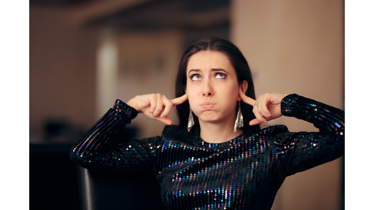 Unhappy Girl Hating the Loud Bad Music at a Party