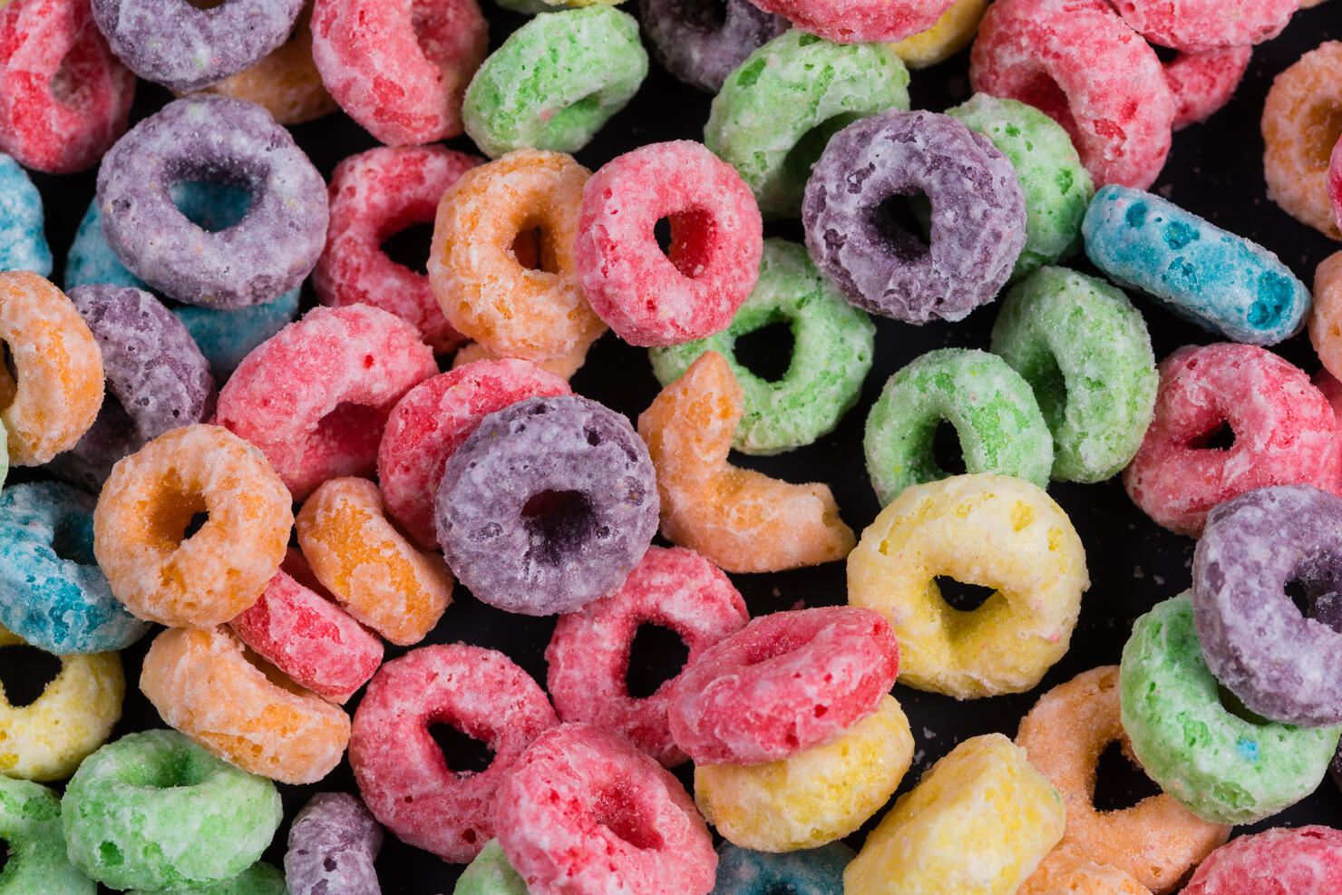 Colorful Fruit O shaped cereal on a black background