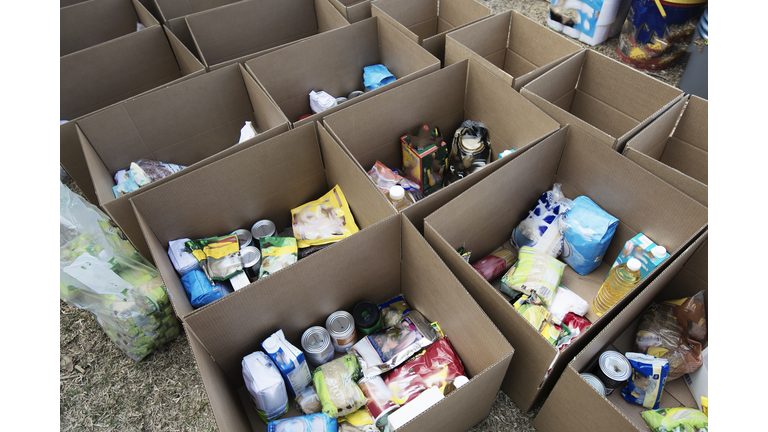 Cardboard boxes being filled with food donations
