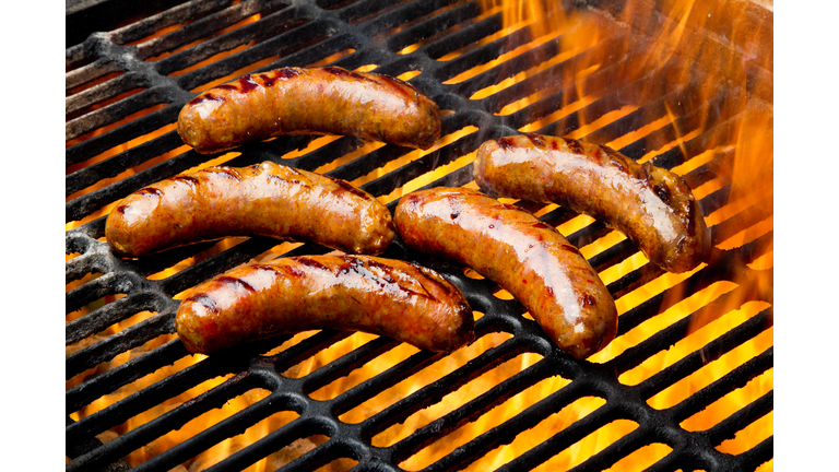 Bratwurst or Hot Dogs on Grill with Flames