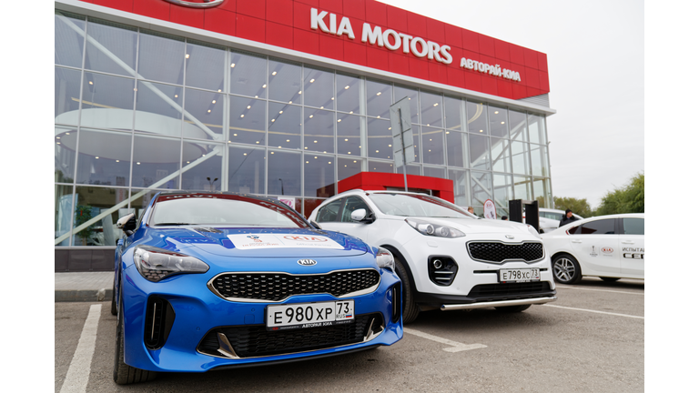 Exhibition car stands in front of the building of KIA MOTORS car selling and service center