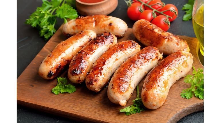 Homemade fried sausages on cutting board