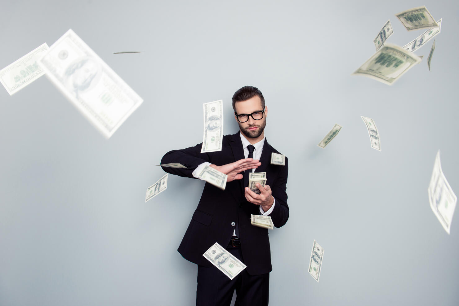 Spectacles jackpot entrepreneur economist banker chic posh manager jacket concept. Handsome confident cunning clever wealthy rich luxury guy holding wasting stack of money isolated on gray background