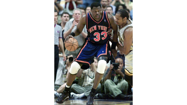 Patrick Ewing (L) of the New York Knicks is guarde
