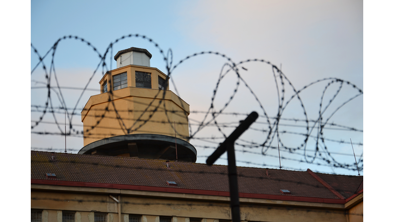 Barbed wire fence layed around prison walls