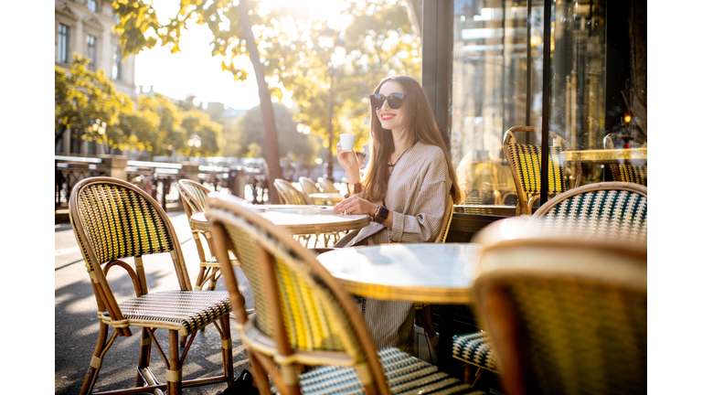 Woman sitting outdoors at the french cafe