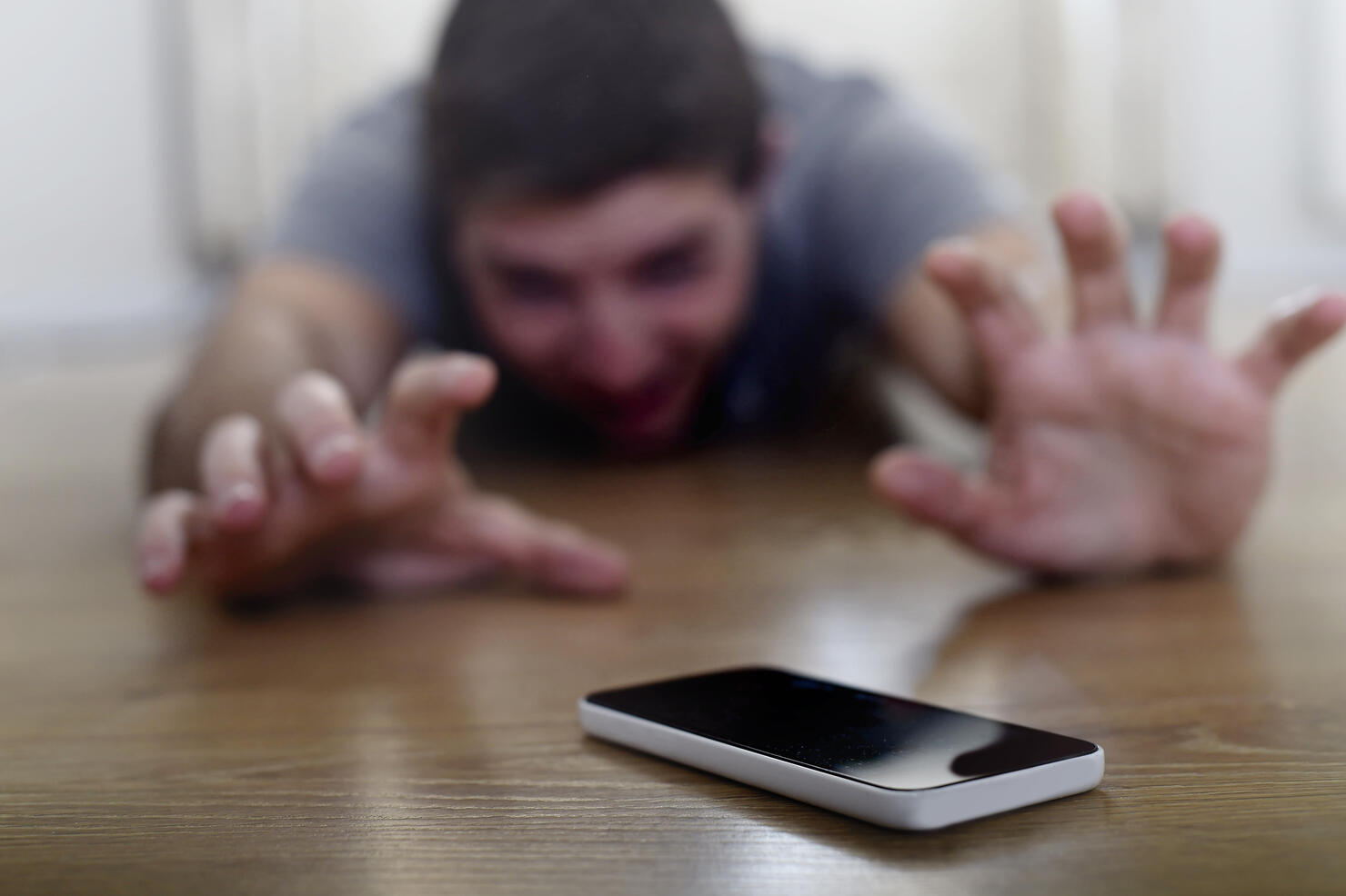 man creeping on ground smart phone and internet addiction concept
