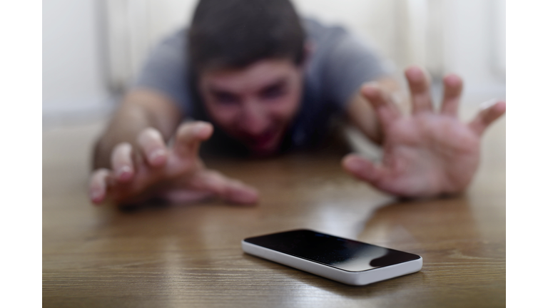 man creeping on ground smart phone and internet addiction concept