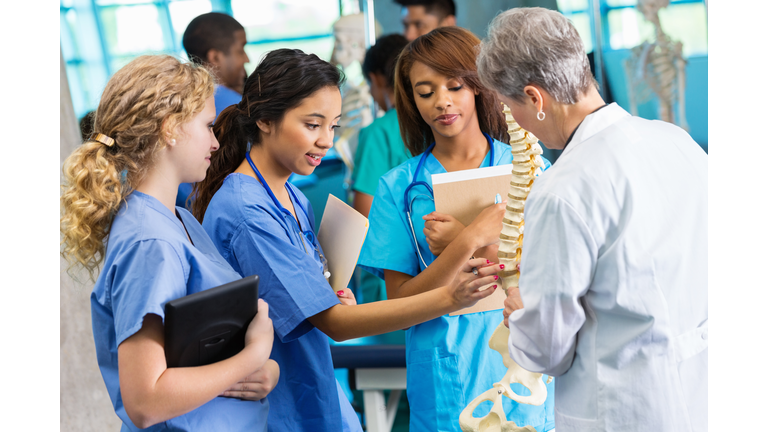 Medical school professor using model to teach nursing students