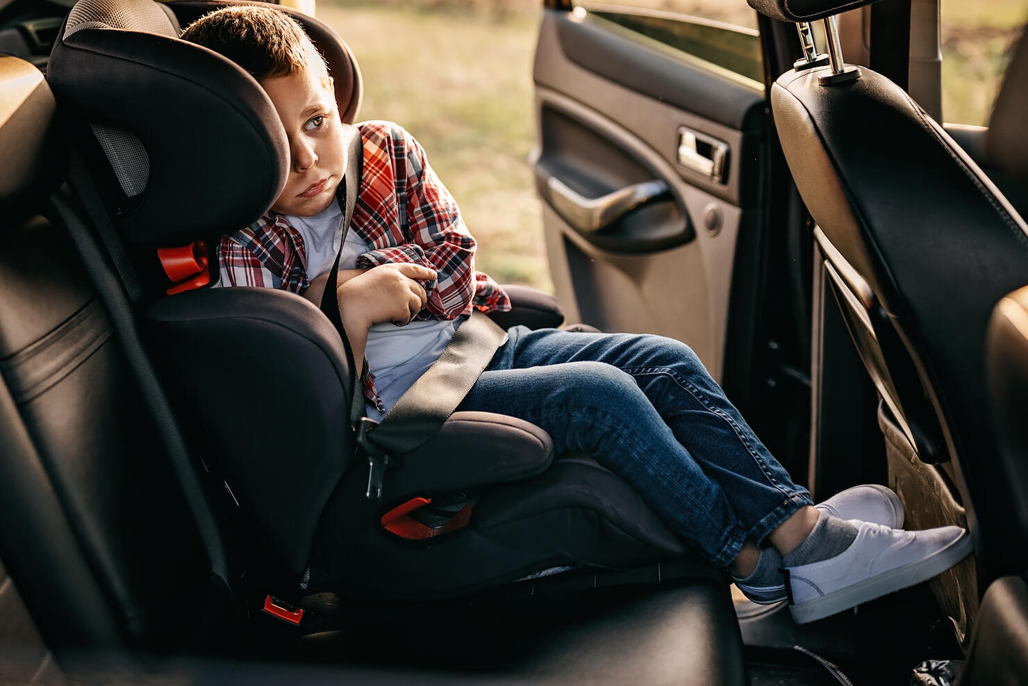 Scared child on back seat of the car