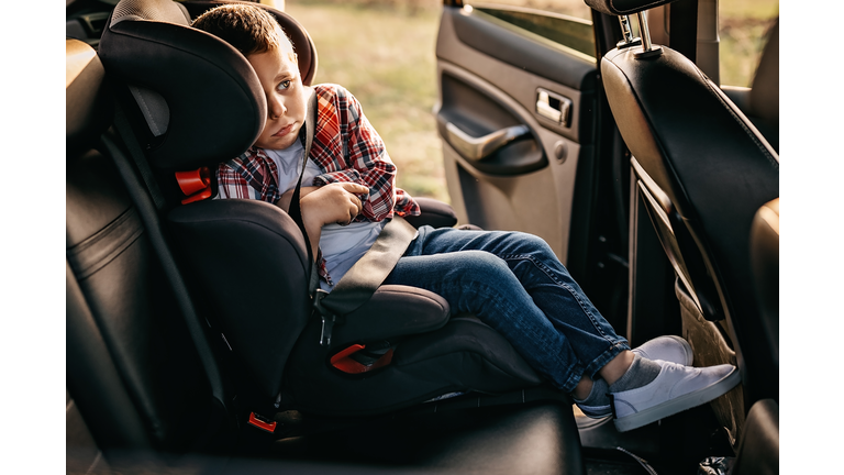 Scared child on back seat of the car