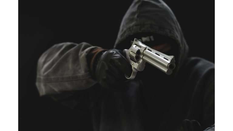 Masked Armed robbers pointing a handgun to robbery the money, Uses Gun in Armed Robbery, Gun Point , used for the illustration or montage of your design, Banner for advertise of product