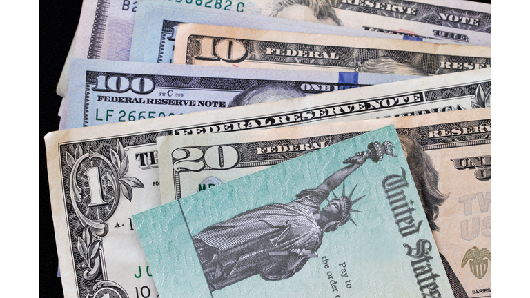 Treasury check on top of various currency bills - corona virus relief