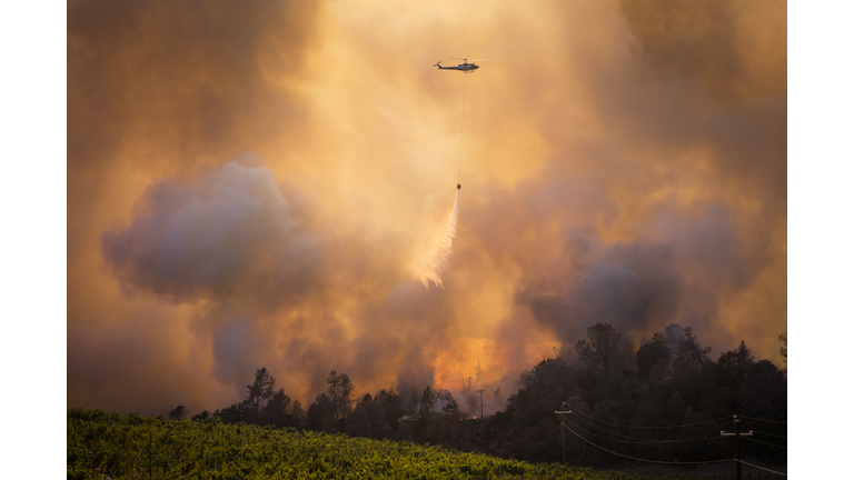 A Helicopter Fighting A Forest Wildfire