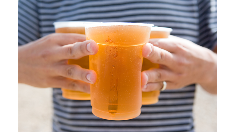 Man carrying cold pints of lager