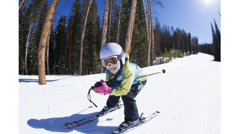 Mixed race girl skiing downhill