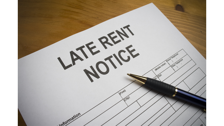Late rent notice paperwork with pen