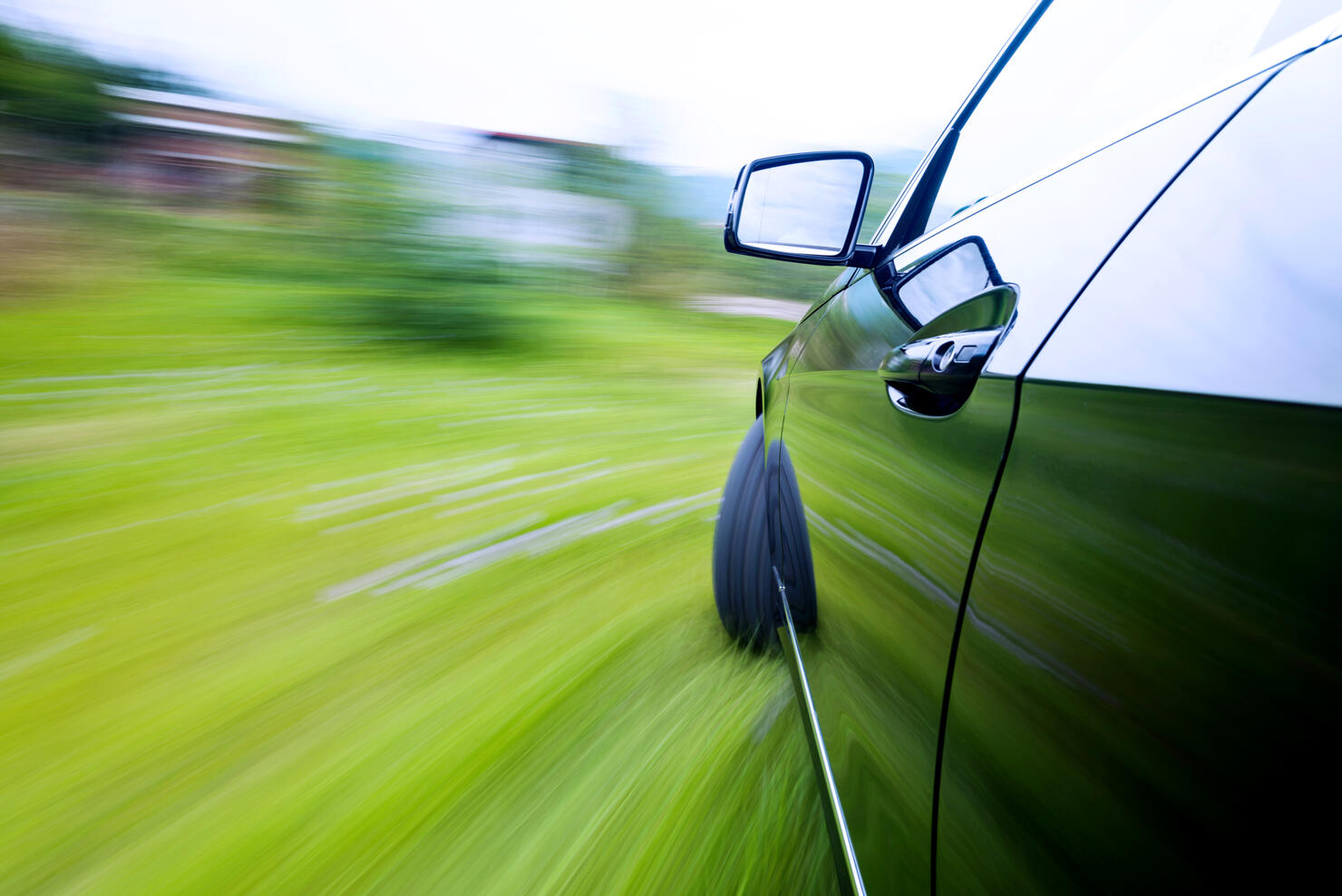 Car driving fast on country road