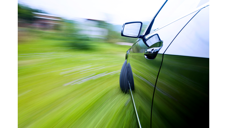 Car driving fast on country road