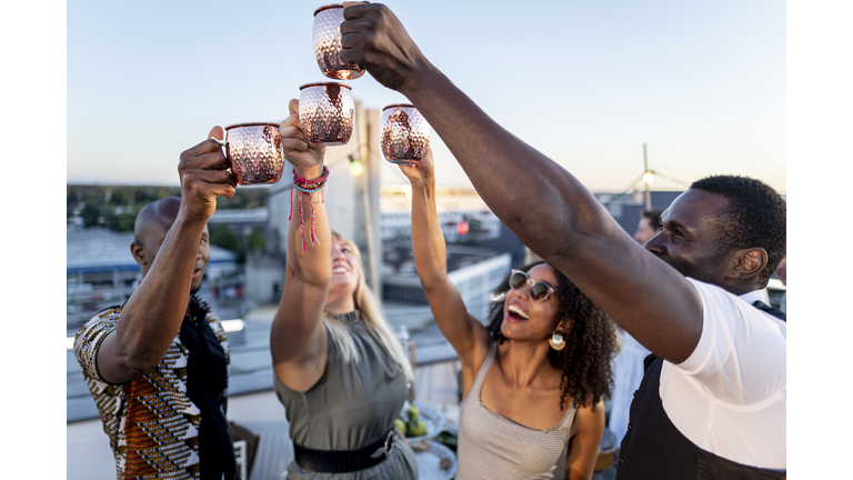 urban rooftop party - trendy group of people partying together