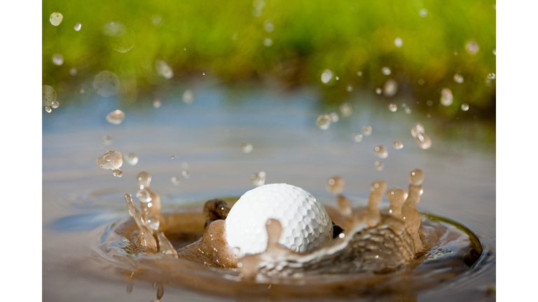 Golf ball splashing into water