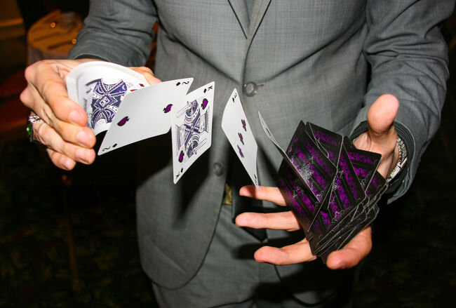 Magician illusionist performing card trick
