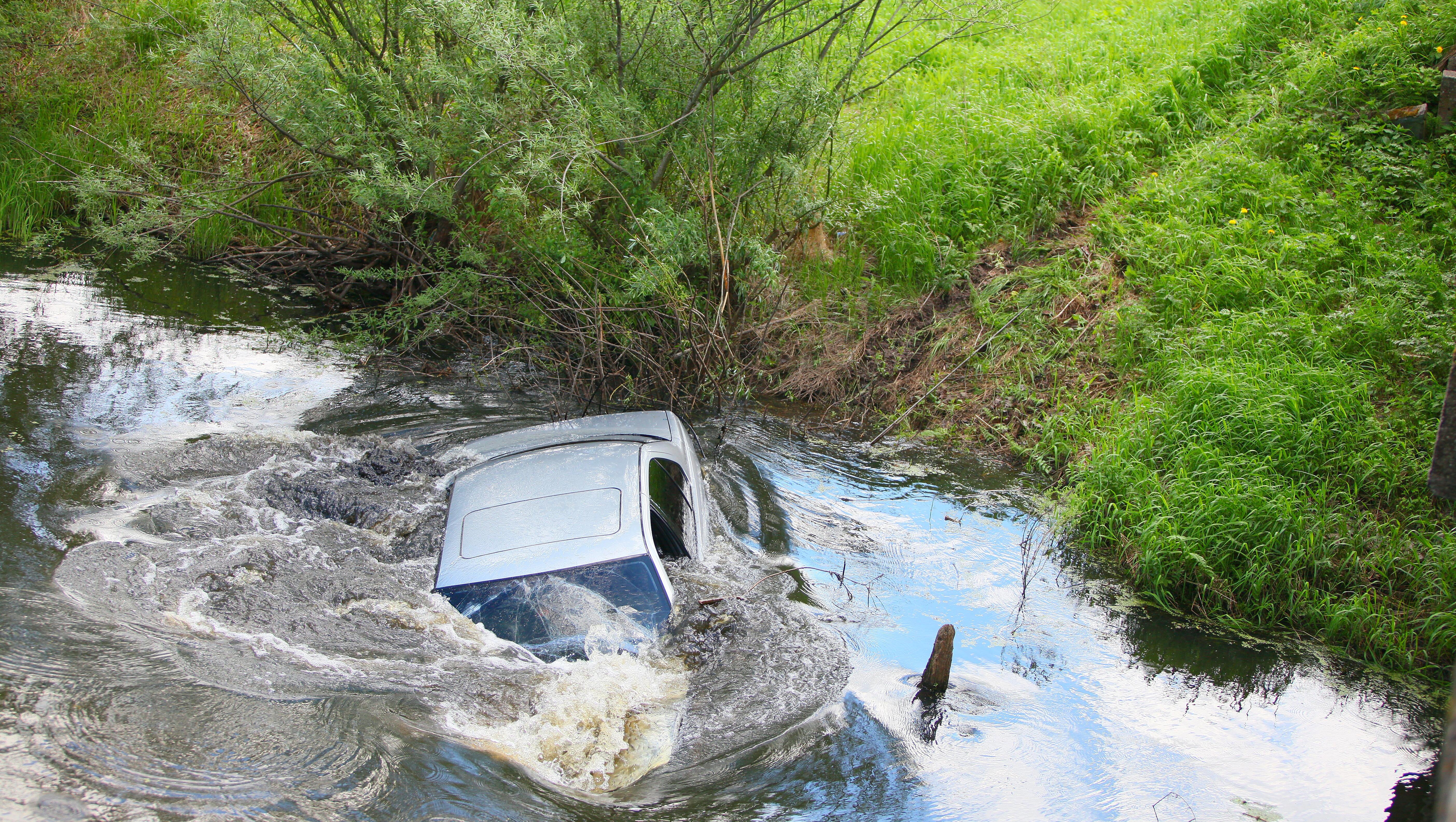 Woman Rescued From Sinking Car After Crashing Into Pond During Heavy Rain