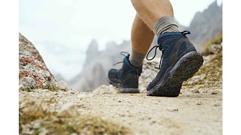 Hiker on dirt track, Canazei, Trentino-Alto Adige, Italy