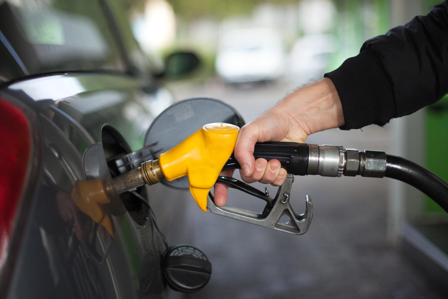 Close-up of hand holding fuel nozzle