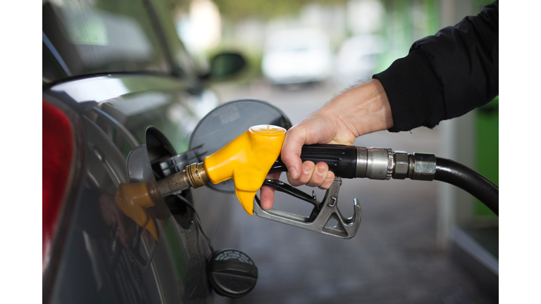 Close-up of hand holding fuel nozzle