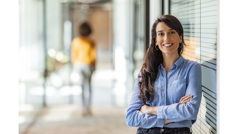 Young mixed race businesswoman smiling to camera