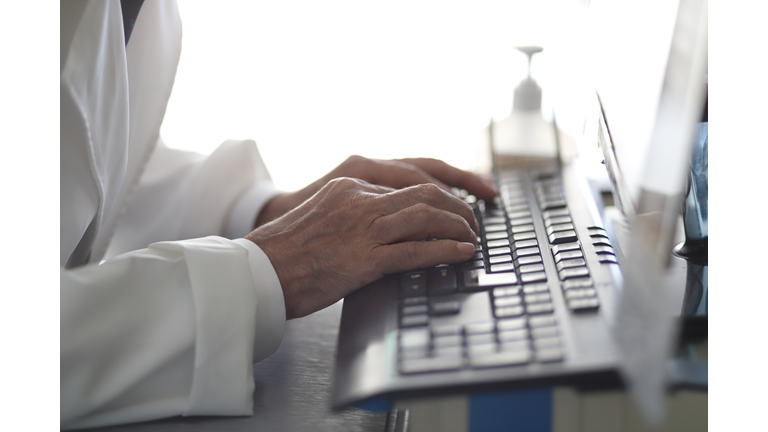 Doctor reviewing records on desktop pc