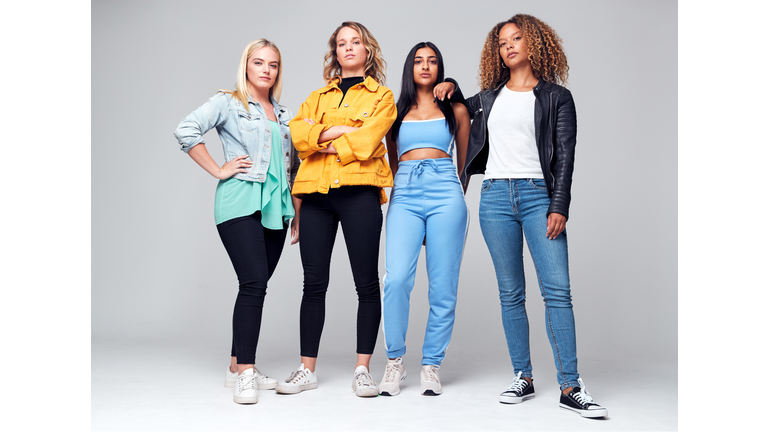 Studio Shot Of Young Independent Multi-Cultural Female Friends Looking Into Camera