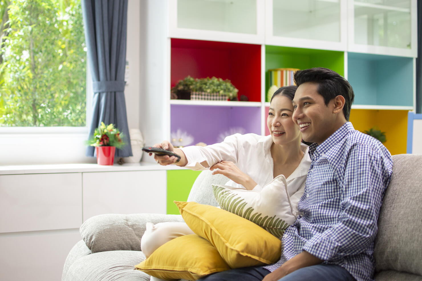 Asian couple lifestyle, man and woman watching TV movies at home, family lifestyle relax and recreation concept