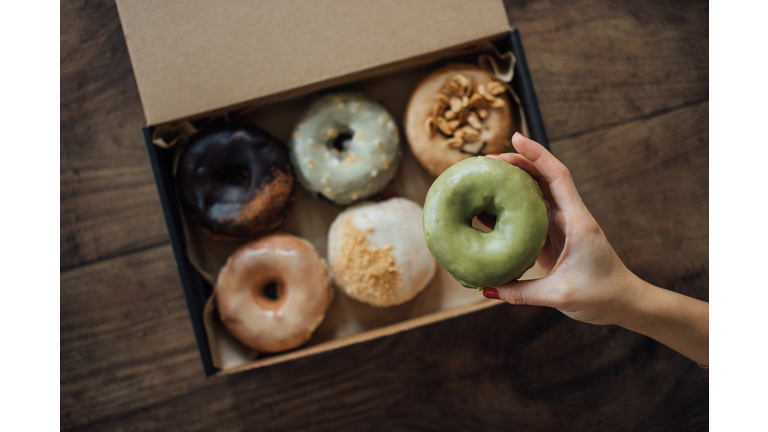 A Choice of Various Delicious Crafted Donuts From A Takeaway Box